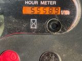 a close up of a meter with a red button
