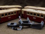 three toy trains sitting on the floor next to each other