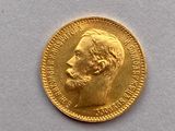 l'image d'une pièce d'or sur laquelle figure le visage d'un homme