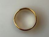 a close up of a gold ring on a white surface