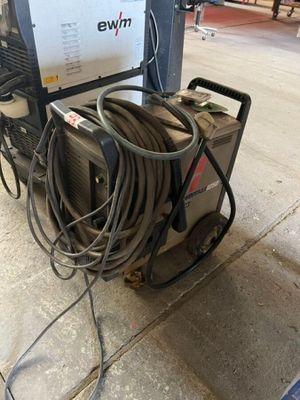 a machine that is sitting on the ground next to some wires