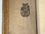 an open book with a picture of a coat of arms on it
