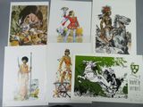 four cards of native americans are displayed on a table