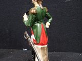 a figurine of a soldier with a sword on a pedestal