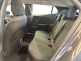 the back seats of a car with a remote control in the passenger seat