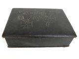 a small black box with writing on it on a white surface