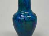 a blue vase that is sitting on a table