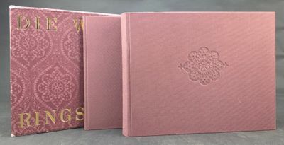 a close up of two pink books on a table