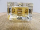 a small square glass box with a label on it on a table