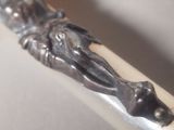 a close up of a pen with a statue on it