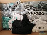 many bags of clothes in a box on the floor