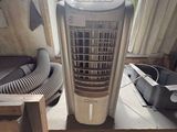a small air conditioner sitting on a table next to a window