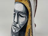 a vase with a painting of a woman on it