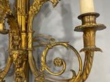 a gold candle holder with two candles attached to it