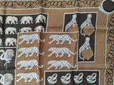 a scarf with a picture of elephants and giraffes on it