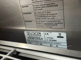 a sign on the side of a stainless steel oven