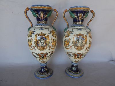 two vases with handles and handles are sitting on a white surface