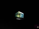 an image of a green and blue diamond in the dark