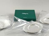 three pieces of silverware sitting on top of a white table