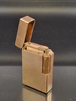 a gold lighter that is sitting on a table