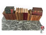 many old books stacked on top of each other