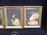 two framed pictures of a woman and a child with a ring on a table