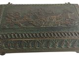 an old bronze box with a horse drawn carriage on it