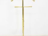 a brass plated coat stand with a circular base