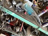 a pile of junk in a room with a lot of tools