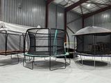 two trampols that are in a building with a tarp over them