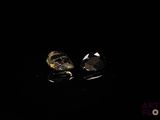 pair of skull earrings in the dark with a black background