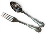 two silver spoons and a fork on a white surface
