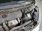 the engine of a car with its hood open on the street