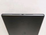 the back of a laptop computer sitting on top of a white table