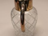 a glass jar with a gold lid sitting on a table