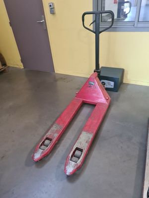 a fork lifter sitting on the floor next to a window
