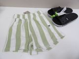 green and white striped shorts and flip flops on a white table