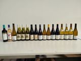 many bottles of wine lined up on a table