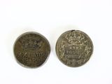 two coins with a crown on them sitting next to each other