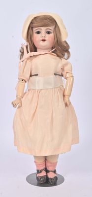 an image of a doll of a woman in a dress and hat