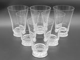 six shot glasses sitting on top of a table next to each other