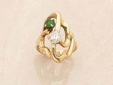a gold ring with a diamond and a green stone