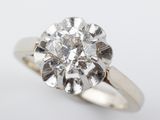a close up of a diamond ring on a white surface