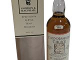 a bottle of whisky sitting next to a cardboard box
