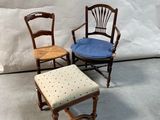 three chairs and a stool in front of a white backdrop