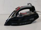 a black and red steam iron sitting on a white surface