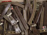 a box full of model train tracks and other toy trains