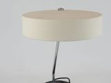 a black and white table lamp with a white shade on it