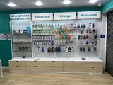 a display of cell phones on the wall in a store