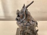 a statue of a dragon sitting on top of a table